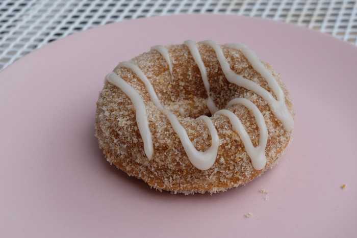 A gluten-free apple cider donut on a pink plate